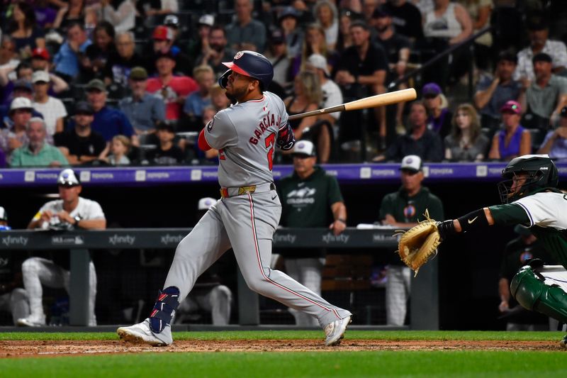 Jun 22, 2024; Denver, Colorado, USA; Washington Nationals second base Luis Garcia Jr. (2) hits a home run against the Colorado Rockies in the eighth inning at Coors Field. Mandatory Credit: John Leyba-USA TODAY Sports