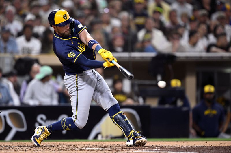 Jun 21, 2024; San Diego, California, USA; Milwaukee Brewers first baseman Rhys Hoskins (12) hits an RBI single during the fifth inning against the San Diego Padres at Petco Park. Mandatory Credit: Orlando Ramirez-USA TODAY Sports