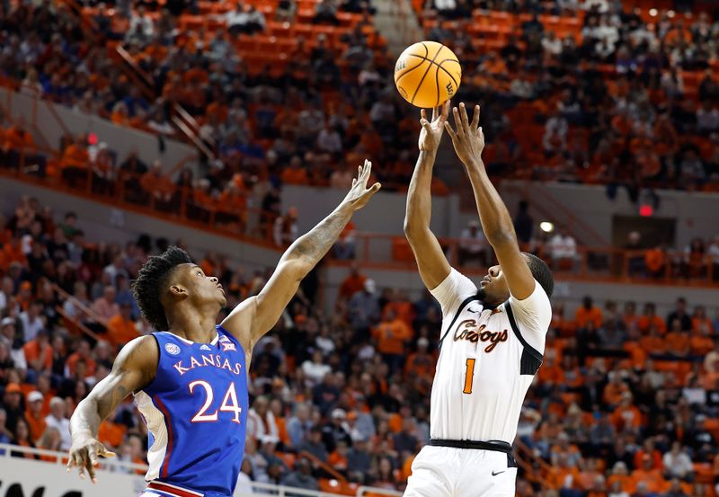 Feb 14, 2023; Stillwater, Oklahoma, USA; Oklahoma State Cowboys guard Bryce Thompson (1) against Kansas Jayhawks forward K.J. Adams Jr. (24) during the first half at Gallagher-Iba Arena. Mandatory Credit: Alonzo Adams-USA TODAY Sports