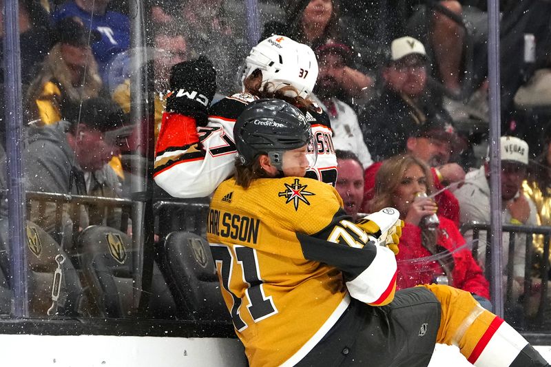 Apr 18, 2024; Las Vegas, Nevada, USA; Vegas Golden Knights center William Karlsson (71) avoids the check attempt of Anaheim Ducks defenseman William Lagesson (37) during the second period at T-Mobile Arena. Mandatory Credit: Stephen R. Sylvanie-USA TODAY Sports