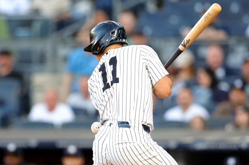 May 20, 2024; Bronx, New York, USA; New York Yankees shortstop Anthony Volpe (11) is hit by a pitch during the first inning against the Seattle Mariners at Yankee Stadium. Mandatory Credit: Brad Penner-USA TODAY Sports