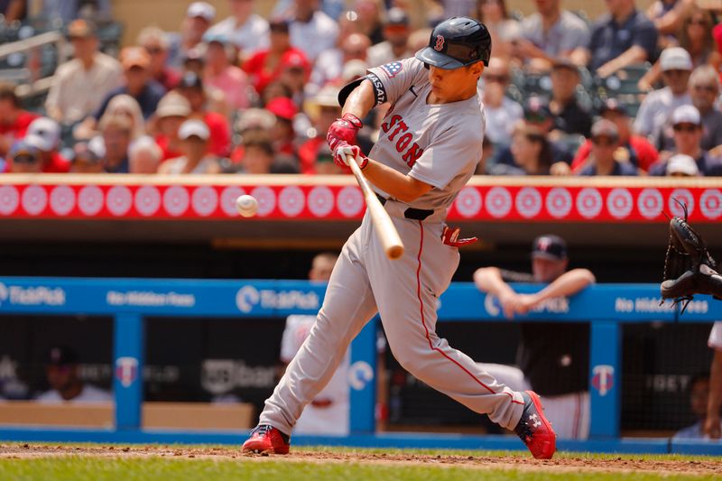 Jul 30, 2025; Minneapolis, Minnesota, USA; Boston Red Sox designated hitter Masataka Yoshida (7) hits a 2 RBI single against the Minnesota Twins in the fifth inning at Target Field. Mandatory Credit: Bruce Kluckhohn-Imagn Images