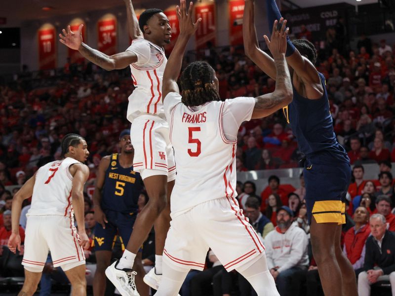 Jan 15, 2025; Houston, Texas, USA; West Virginia Mountaineers center Eduardo Andre (0) is defended by Houston Cougars forward Ja'Vier Francis (5) in the first half at Fertitta Center. Mandatory Credit: Thomas Shea-Imagn Images