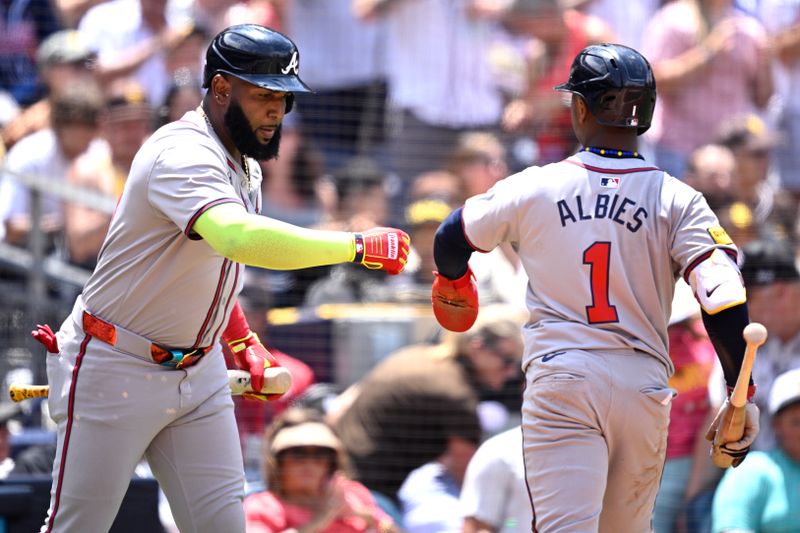 Jul 14, 2024; San Diego, California, USA; Atlanta Braves second baseman Ozzie Albies (1) is congratulated by designated hitter Marcell Ozuna (20) after scoring a run against the San Diego Padres during the fourth inning at Petco Park. Mandatory Credit: Orlando Ramirez-USA TODAY Sports