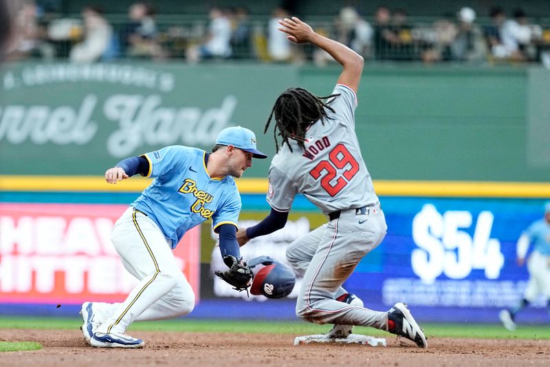 Jul 12, 2024; Milwaukee, Wisconsin, USA;  Washington Nationals left fielder James Wood (29) steals second base before Milwaukee Brewers second baseman Brice Turang (2) can apply the tag during the third inning at American Family Field. Mandatory Credit: Jeff Hanisch-USA TODAY Sports