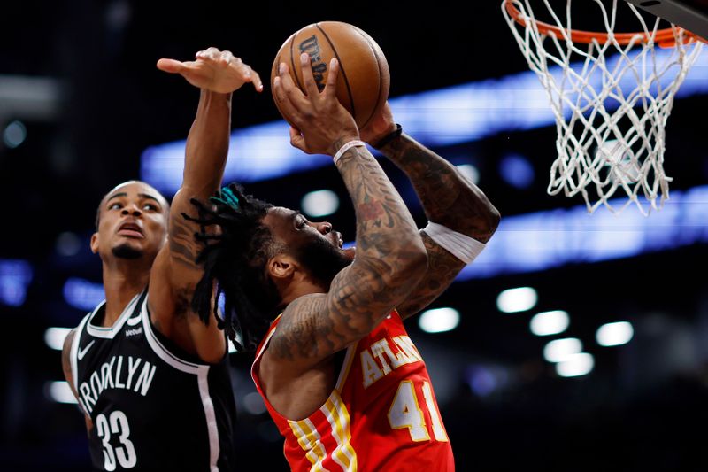 NEW YORK, NEW YORK - MARCH 02: Saddiq Bey #41 of the Atlanta Hawks goes to the basket as Nic Claxton #33 of the Brooklyn Nets during the second half at Barclays Center on March 02, 2024 in the Brooklyn borough of New York City. The Nets won 114-102. NOTE TO USER: User expressly acknowledges and agrees that, by downloading and or using this photograph, User is consenting to the terms and conditions of the Getty Images License Agreement. (Photo by Sarah Stier/Getty Images)