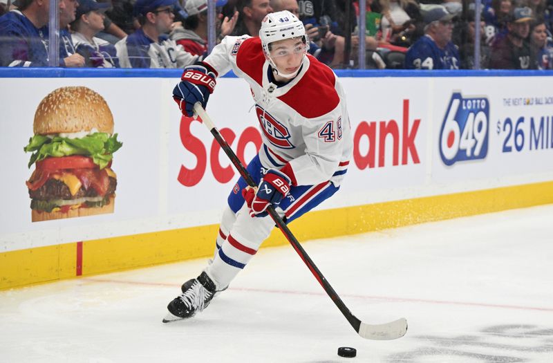 Sep 26, 2024; Toronto, Ontario, CAN;  Montreal Canadiens forward Lane Hutson (48) skates with the puck against the Toronto Maple Leafs in the third period at Scotiabank Arena. Mandatory Credit: Dan Hamilton-Imagn Images