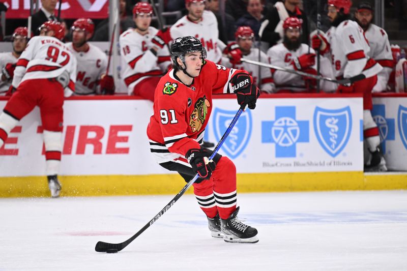 Apr 14, 2024; Chicago, Illinois, USA;  Chicago Blackhawks forward Frank Nazar (91) controls the puck in the second period against the Carolina Hurricanes at United Center. Mandatory Credit: Jamie Sabau-USA TODAY Sports