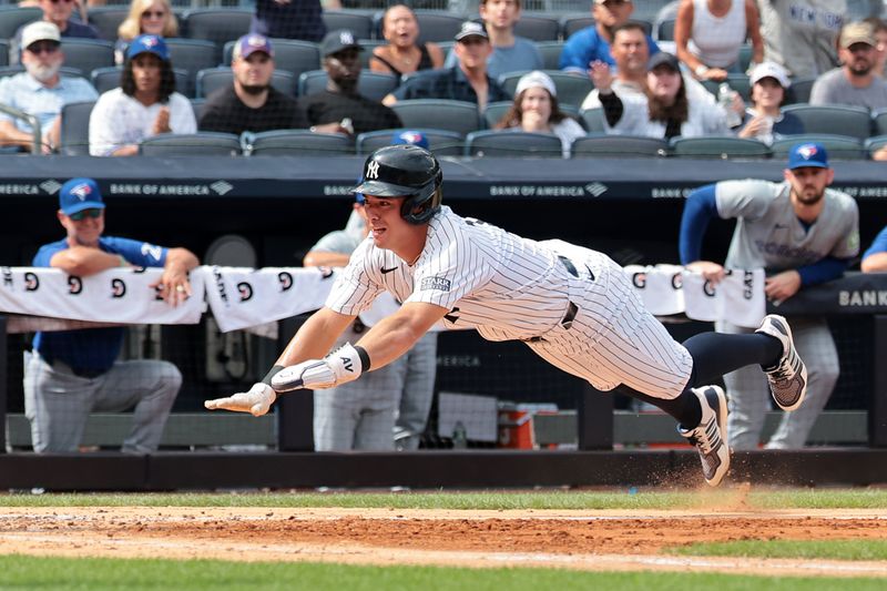 Aug 4, 2024; Bronx, New York, USA;  New York Yankees shortstop Anthony Volpe (11) scores a run on an RBI by third baseman DJ LeMahieu (26) sacrifice fly during the sixth inning against the Toronto Blue Jays at Yankee Stadium. Mandatory Credit: Vincent Carchietta-USA TODAY Sports