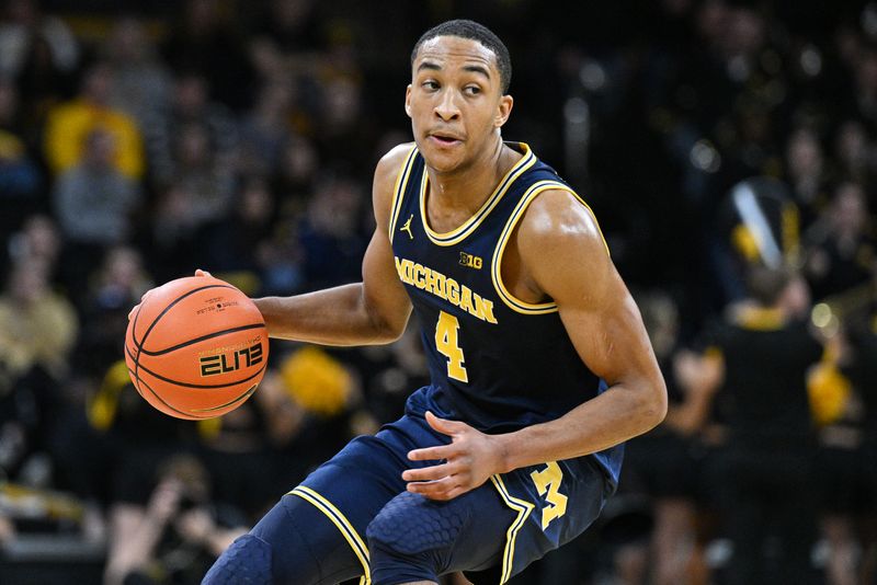 Dec 10, 2023; Iowa City, Iowa, USA; Michigan Wolverines guard Nimari Burnett (4) controls the ball against the Iowa Hawkeyes during the first half at Carver-Hawkeye Arena. Mandatory Credit: Jeffrey Becker-USA TODAY Sports