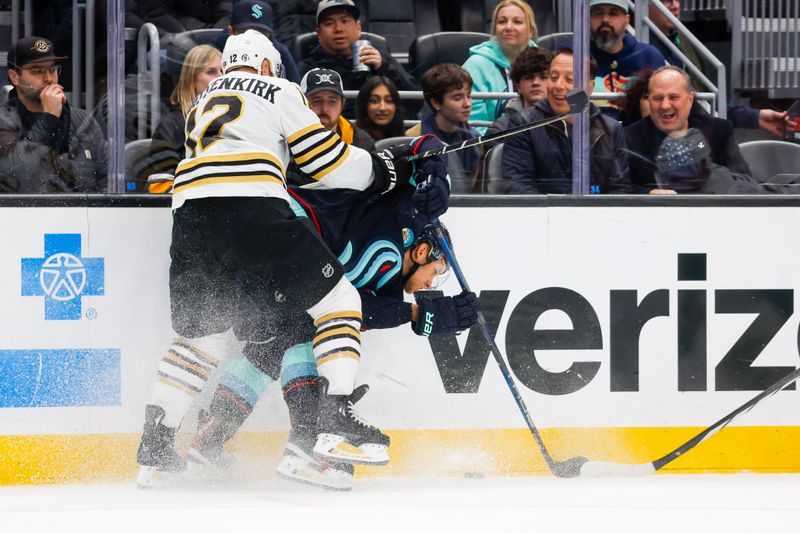 Feb 26, 2024; Seattle, Washington, USA; Boston Bruins defenseman Kevin Shattenkirk (12) checks Seattle Kraken center Jaden Schwartz (17) against the boards during the first period at Climate Pledge Arena. Mandatory Credit: Joe Nicholson-USA TODAY Sports