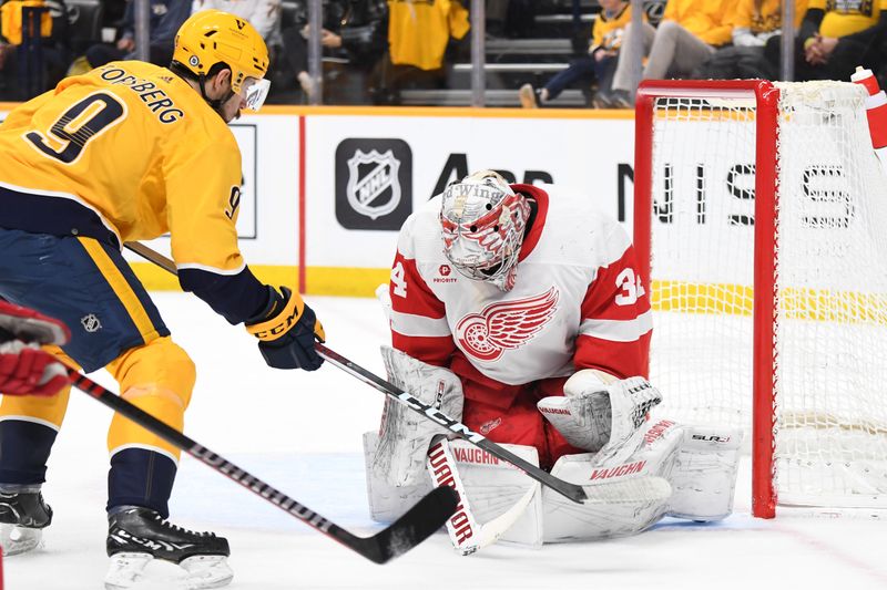 Mar 23, 2024; Nashville, Tennessee, USA; Detroit Red Wings goaltender Alex Lyon (34) makes a save on a shot by Nashville Predators left wing Filip Forsberg (9) during the first period at Bridgestone Arena. Mandatory Credit: Christopher Hanewinckel-USA TODAY Sports