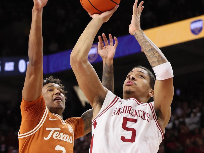 Mar 4, 2026; Fayetteville, Arkansas, USA; Arkansas Razorbacks guard Darius Acuff Jr (5) shoots as guard Dailyn Swain (3) defends during the first half at Bud Walton Arena. Mandatory Credit: Nelson Chenault-Imagn Images