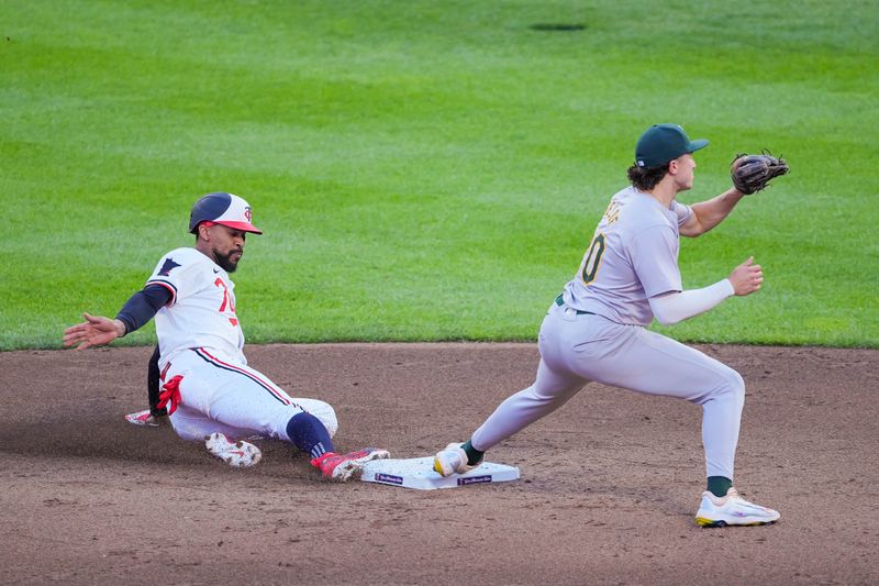 Jun 13, 2024; Minneapolis, Minnesota, USA; Oakland Athletics second base Zack Gelof (20) catches the ball for an out against the Minnesota Twins outfielder Byron Buxton (25) in the sixth inning at Target Field. Mandatory Credit: Brad Rempel-USA TODAY Sports