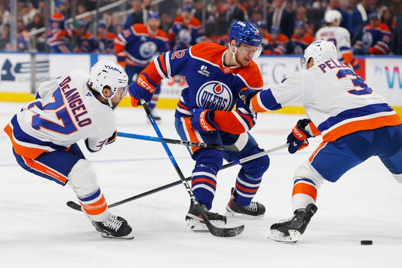 Jan 15, 2026; Edmonton, Alberta, CAN; New York Islanders defensemen Tony DeAngelo (77) and defensemen Adam Pelech (3) battle Edmonton Oilers forward Vasily Podkolzin (92) for the puck during the first period at Rogers Place. Mandatory Credit: Perry Nelson-Imagn Images