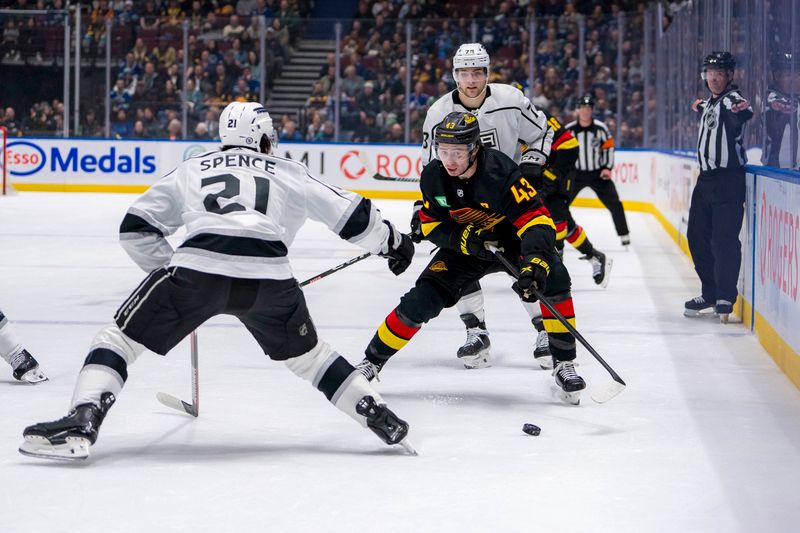 Mar 25, 2024; Vancouver, British Columbia, CAN; Vancouver Canucks defenseman Quinn Hughes (43) drives on Los Angeles Kings defenseman Jordan Spence (21) in the first period at Rogers Arena. Mandatory Credit: Bob Frid-USA TODAY Sports