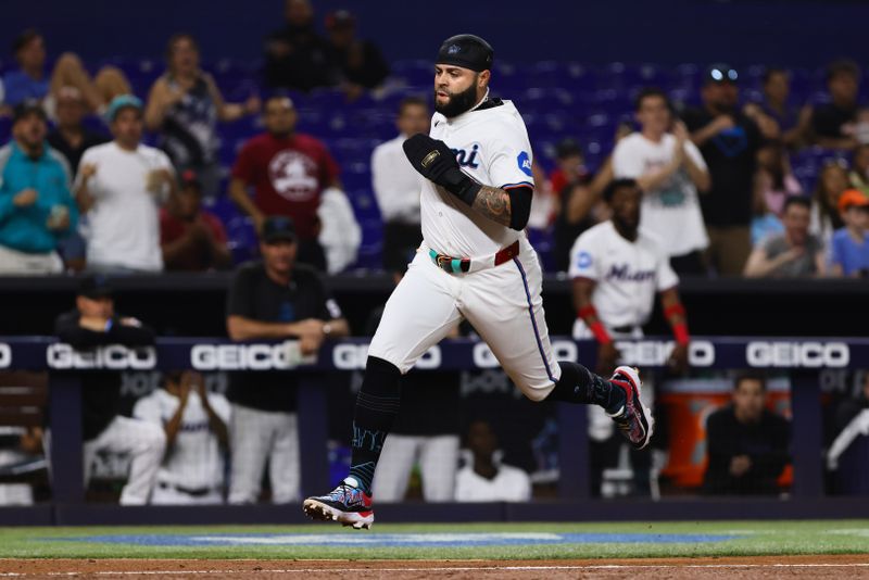 May 1, 2024; Miami, Florida, USA; Miami Marlins third baseman Emmanuel Rivera (15) scores after an RBI single by second baseman Luis Arraez (not pictured) during the fifth inning at loanDepot Park. Mandatory Credit: Sam Navarro-USA TODAY Sports