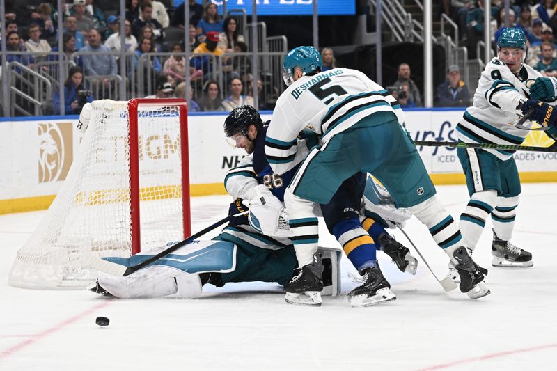 Mar 26, 2026; St. Louis, Missouri, USA; St. Louis Blues left wing Nathan Walker (26) and San Jose Sharks defenseman Vincent Desharnais (5) collides with San Jose Sharks goaltender Yaroslav Askarov (30) in the second period at Enterprise Center. Mandatory Credit: Joe Puetz-Imagn Images