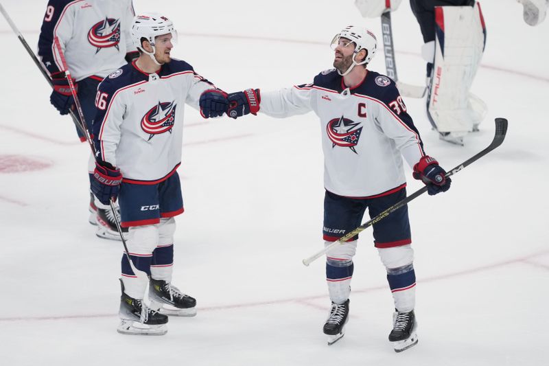 Feb 17, 2024; San Jose, California, USA; Columbus Blue Jackets center Boone Jenner (38) celebrates with right wing Kirill Marchenko (86) after scoring a goal against the San Jose Sharks during the third period at SAP Center at San Jose. Mandatory Credit: Darren Yamashita-USA TODAY Sports