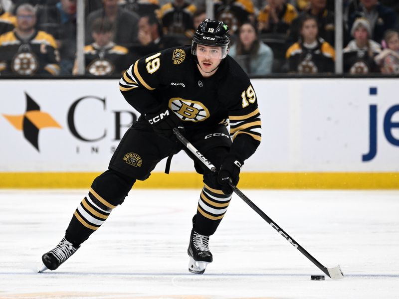 Nov 9, 2023; Boston, Massachusetts, USA; Boston Bruins center Johnny Beecher (19) skaters with the puck against the New York Islanders during the third period at the TD Garden. Mandatory Credit: Brian Fluharty-USA TODAY Sports