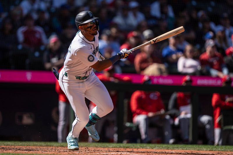 Apr 17, 2024; Seattle, Washington, USA; Seattle Mariners centerfielder Julio Rodriguez (44) hits a single during the eighth inning against the Cincinnati Reds at T-Mobile Park. Mandatory Credit: Stephen Brashear-USA TODAY Sports