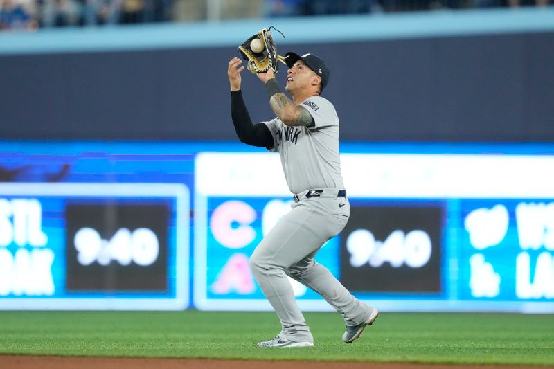 Apr 16, 2024; Toronto, Ontario, CAN; New York Yankees second baseman Gleyber Torres (25) catches a pop up hit by Toronto Blue Jays second baseman Isiah Kiner-Falefa (not pictured) during the fourth inning at Rogers Centre. Mandatory Credit: John E. Sokolowski-USA TODAY Sports