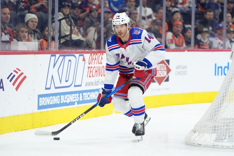 Jan 17, 2026; Philadelphia, Pennsylvania, USA; New York Rangers right wing Taylor Raddysh (14) controls the puck against the Philadelphia Flyers in the first period at Xfinity Mobile Arena. Mandatory Credit: Kyle Ross-Imagn Images