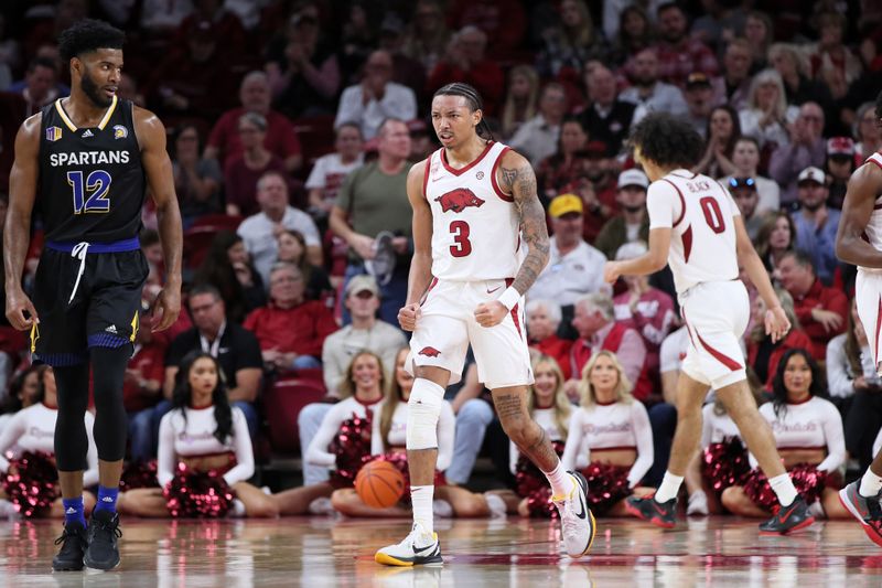 Dec 3, 2022; Fayetteville, Arkansas, USA; Arkansas Razorbacks guard Nick Smith Jr (3) celebrates after a play in the second half as San Jose State Spartans forward Sage Tolbert III (23) look son at Bud Walton Arena. Arkansas won 99-58. Mandatory Credit: Nelson Chenault-USA TODAY Sports