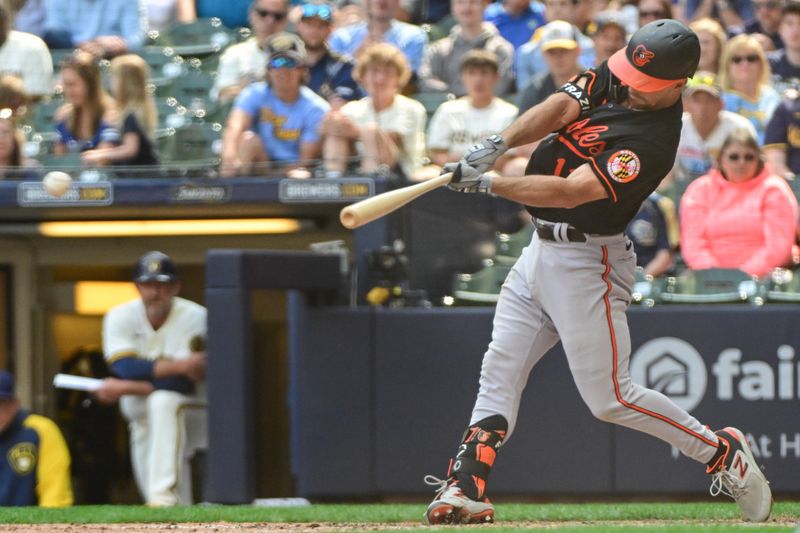 Jun 8, 2023; Milwaukee, Wisconsin, USA; Baltimore Orioles second baseman Adam Frazier (12) hits a double to drive in 2 runs against the Milwaukee Brewers in the ninth inning at American Family Field. Mandatory Credit: Benny Sieu-USA TODAY Sports