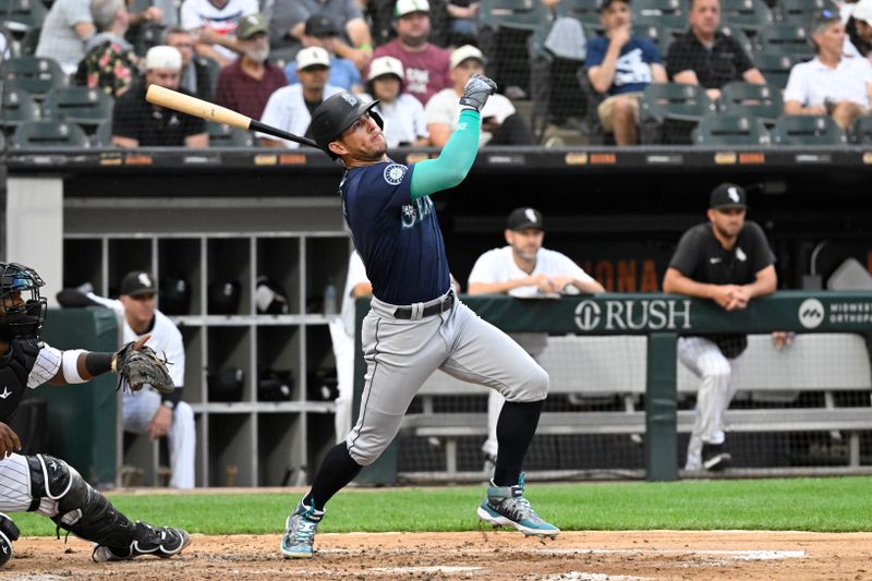 Jul 27, 2024; Chicago, Illinois, USA;  Seattle Mariners shortstop Dylan Moore (25) hits an RBI single against the Chicago White Sox during the fourth inning at Guaranteed Rate Field. Mandatory Credit: Matt Marton-USA TODAY Sports