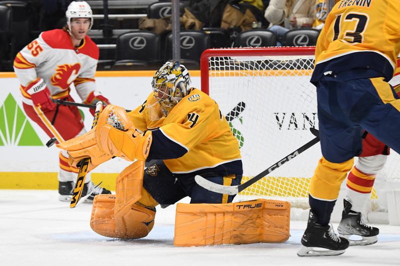 Jan 4, 2024; Nashville, Tennessee, USA; Nashville Predators goaltender Juuse Saros (74) makes a save during the second period against the Calgary Flames at Bridgestone Arena. Mandatory Credit: Christopher Hanewinckel-USA TODAY Sports