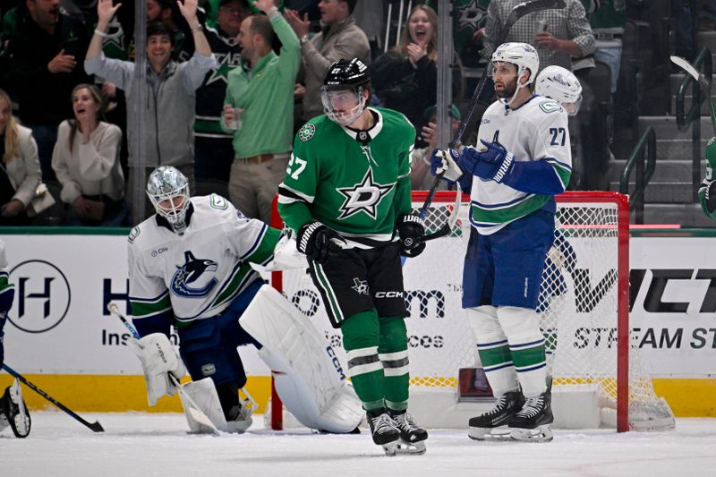 Apr 8, 2025; Dallas, Texas, USA; Dallas Stars left wing Mason Marchment (27) celebrates scoring a goal against Vancouver Canucks goaltender Thatcher Demko (35) as defenseman Derek Forbort (27) looks on during the first period at the American Airlines Center. Mandatory Credit: Jerome Miron-Imagn Images