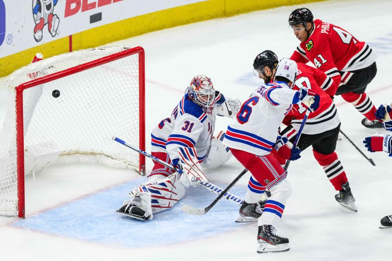 Feb 9, 2024; Chicago, Illinois, USA; Chicago Blackhawks left wing Nick Foligno (17) scores past New York Rangers goaltender Igor Shesterkin (31) during the third period at the United Center. Mandatory Credit: Daniel Bartel-USA TODAY Sports