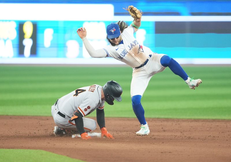 Jun 29, 2023; Toronto, Ontario, CAN; San Francisco Giants catcher Patrick Bailey (14) is safe at second base against the Toronto Blue Jays during the ninth inning at Rogers Centre. Mandatory Credit: Nick Turchiaro-USA TODAY Sports