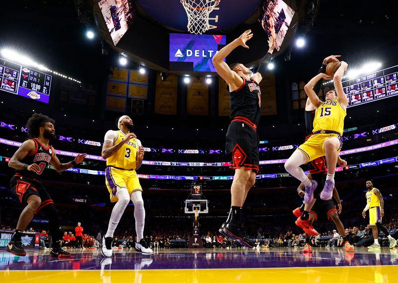 LOS ANGELES, CALIFORNIA - JANUARY 25:  Austin Reaves #15 of the Los Angeles Lakers takes a shot against Nikola Vucevic #9 of the Chicago Bulls in the second half at Crypto.com Arena on January 25, 2024 in Los Angeles, California.  NOTE TO USER: User expressly acknowledges and agrees that, by downloading and/or using this photograph, user is consenting to the terms and conditions of the Getty Images License Agreement.  (Photo by Ronald Martinez/Getty Images)