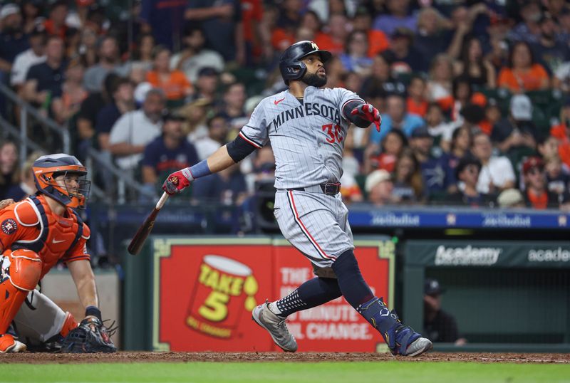 May 31, 2024; Houston, Texas, USA; Minnesota Twins first baseman Carlos Santana (30) hits a home run during the eighth inning against the Houston Astros at Minute Maid Park. Mandatory Credit: Troy Taormina-USA TODAY Sports