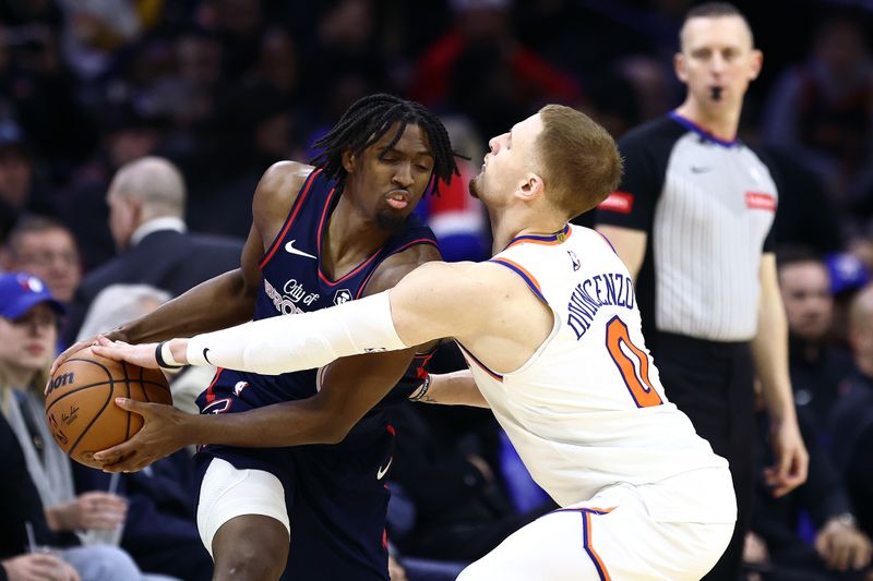 PHILADELPHIA, PENNSYLVANIA - FEBRUARY 22: Tyrese Maxey #0 of the Philadelphia 76ers is guarded by Donte DiVincenzo #0 of the New York Knicks during the third quarter at the Wells Fargo Center on February 22, 2024 in Philadelphia, Pennsylvania. (Photo by Tim Nwachukwu/Getty Images)