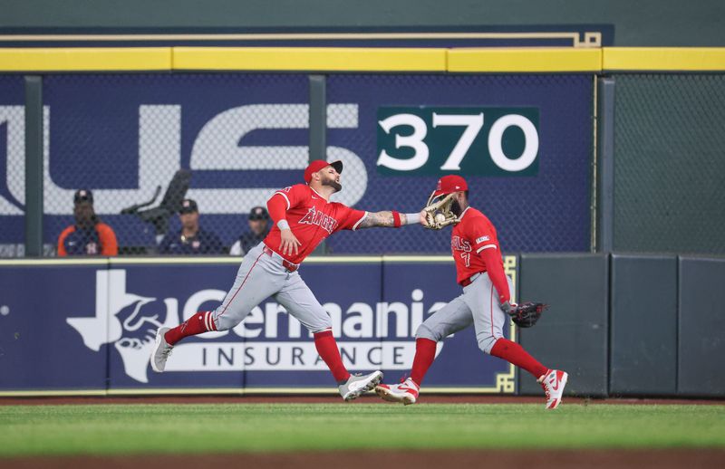 May 21, 2024; Houston, Texas, USA; Los Angeles Angels center fielder Kevin Pillar (12) makes a catch during the second inning against the Houston Astros at Minute Maid Park. Mandatory Credit: Troy Taormina-USA TODAY Sports