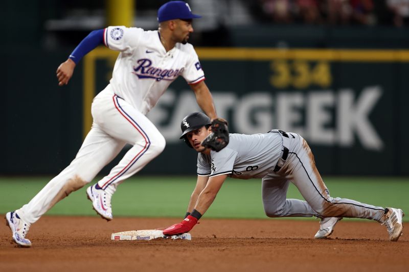 Jul 25, 2024; Arlington, Texas, USA; Chicago White Sox short stop Nicky Lopez (8) steals second base as Texas Rangers second base Marcus Semien (2) chases the ball in the fifth inning at Globe Life Field. Mandatory Credit: Tim Heitman-USA TODAY Sports