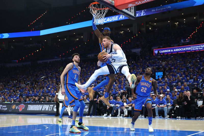 OKLAHOMA CITY, OKLAHOMA - MAY 22: Donte DiVincenzo #0 of the Minnesota Timberwolves comes pulls down a rebound during the second quarter of a game against the Oklahoma City Thunder in Game Two of the Western Conference Finals of the 2025 NBA Playoffs at Paycom Center on May 22, 2025 in Oklahoma City, Oklahoma. NOTE TO USER: User expressly acknowledges and agrees that, by downloading and or using this photograph, User is consenting to the terms and conditions of the Getty Images License Agreement. (Photo by Matthew Stockman/Getty Images)