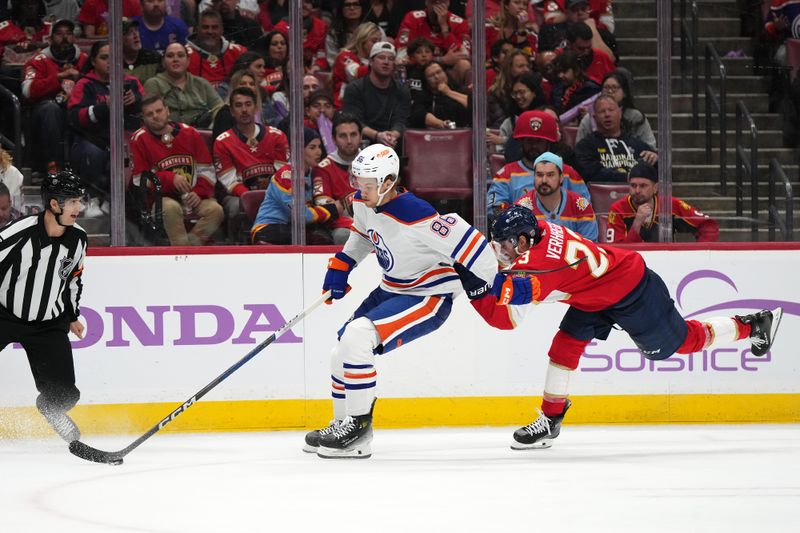 Nov 20, 2023; Sunrise, Florida, USA; Florida Panthers center Carter Verhaeghe (23) battles Edmonton Oilers defenseman Philip Broberg (86) for the puck during the second period at Amerant Bank Arena. Mandatory Credit: Jasen Vinlove-USA TODAY Sports