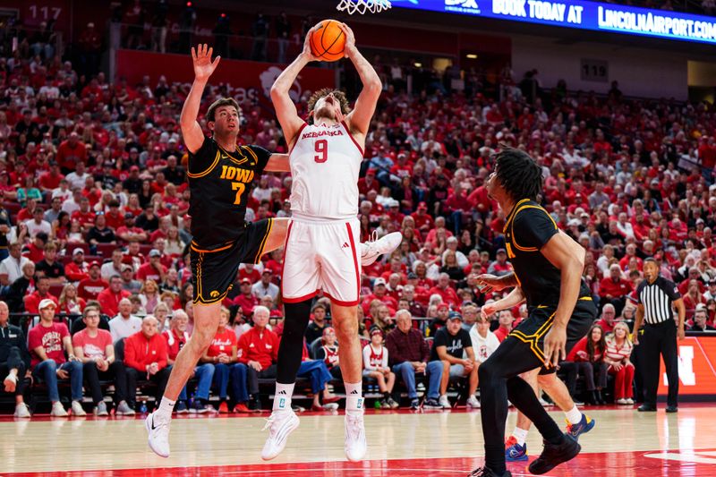Mar 8, 2026; Lincoln, Nebraska, USA; Nebraska Cornhuskers forward Berke Buyuktuncel (9) shoots against Iowa Hawkeyes forward Alvaro Folgueiras (7) and guard Tavion Banks (6) during the first half at Pinnacle Bank Arena. Mandatory Credit: Dylan Widger-Imagn Images Mar 8, 2026; Lincoln, Nebraska, USA; Nebraska Cornhuskers forward Berke Buyuktuncel (9) shoots against Iowa Hawkeyes forward Alvaro Folgueiras (7) and guard Tavion Banks (6) during the first half at Pinnacle Bank Arena. Mandatory Credit: Dylan Widger-Imagn Images