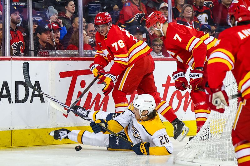 Nov 15, 2024; Calgary, Alberta, CAN; Nashville Predators center Philip Tomasino (26) and Calgary Flames center Martin Pospisil (76) battles for the puck during the first period at Scotiabank Saddledome. Mandatory Credit: Sergei Belski-Imagn Images