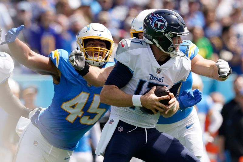 Tennessee Titans quarterback Ryan Tannehill is sacked by Los Angeles Chargers linebacker Joey Bosa, right, during the first half of an NFL football game Sunday, Sept. 17, 2023, in Nashville, Tenn. (AP Photo/George Walker IV)