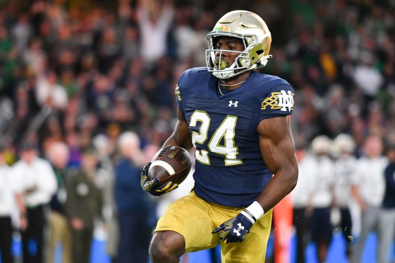 Aug 26, 2023; Dublin, IRL; Notre Dame Fighting Irish running back Jadarian Price (24) carries for a touchdown in the first quarter against the Navy Midshipmen at Aviva Stadium. Mandatory Credit: Matt Cashore-USA TODAY Sports