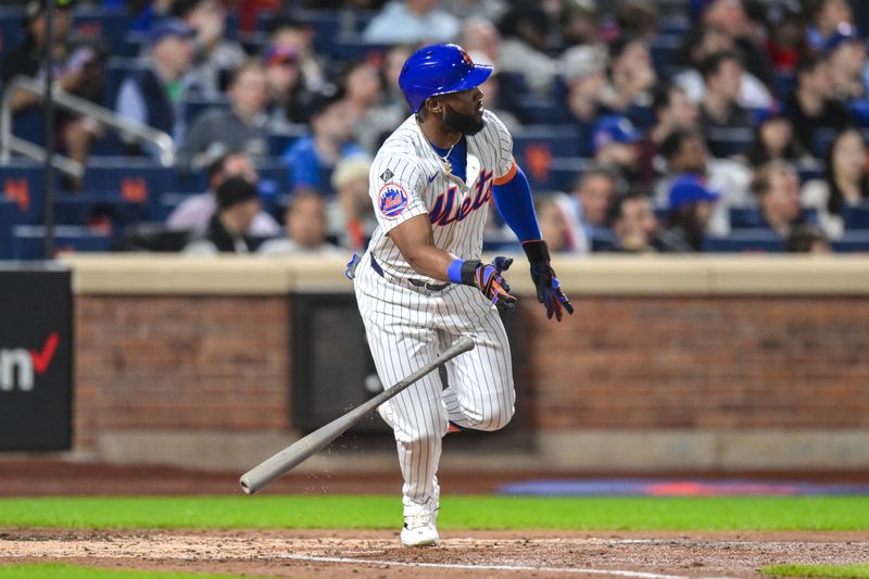 Apr 15, 2024; New York City, New York, USA; New York Mets outfielder Starling Marte (42) hits a double against the Pittsburgh Pirates during the third inning at Citi Field. Mandatory Credit: John Jones-USA TODAY Sports