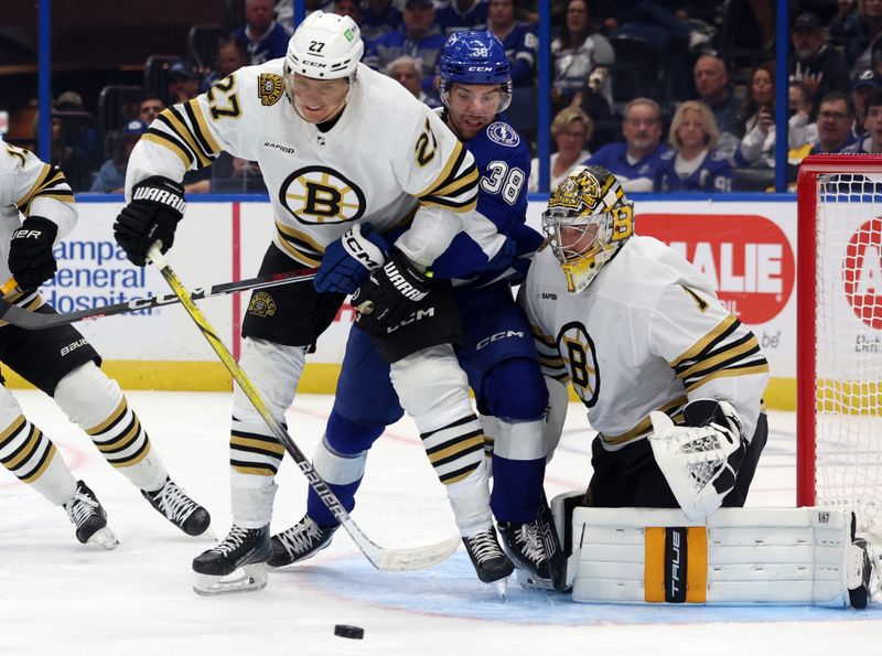 Nov 20, 2023; Tampa, Florida, USA; Boston Bruins defenseman Hampus Lindholm (27) and Jeremy Swayman (1) defend Tampa Bay Lightning left wing Brandon Hagel (38) during the first period at Amalie Arena. Mandatory Credit: Kim Klement Neitzel-USA TODAY Sports