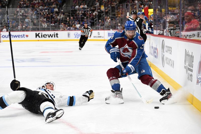 Sep 29, 2024; Denver, Colorado, USA; Colorado Avalanche left wing Miles Wood (28) handles the puck as Utah Hockey Club forward Barrett Hayton (27) falls to the ice during the second period at Ball Arena. Mandatory Credit: Christopher Hanewinckel-Imagn Images