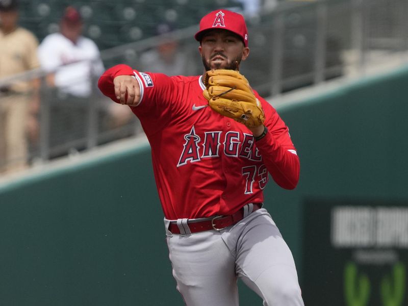 Mar 23, 2024; Mesa, Arizona, USA; Los Angeles Angels second baseman Livan Soto (73) makes the off balance throw for an out against the Oakland Athletics in the first inning at Hohokam Stadium. Mandatory Credit: Rick Scuteri-USA TODAY Sports