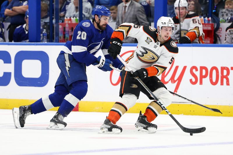 Jan 13, 2024; Tampa, Florida, USA;  Anaheim Ducks defenseman Urho Vaakanainen (5) controls the puck from Tampa Bay Lightning left wing Nicholas Paul (20) in the second period at Amalie Arena. Mandatory Credit: Nathan Ray Seebeck-USA TODAY Sports